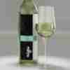 A pour of 2024 Sauvignon Blanc with label shown on bottle